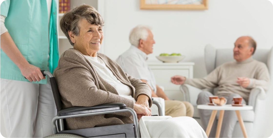 A woman in a wheelchair smiling at the camera.