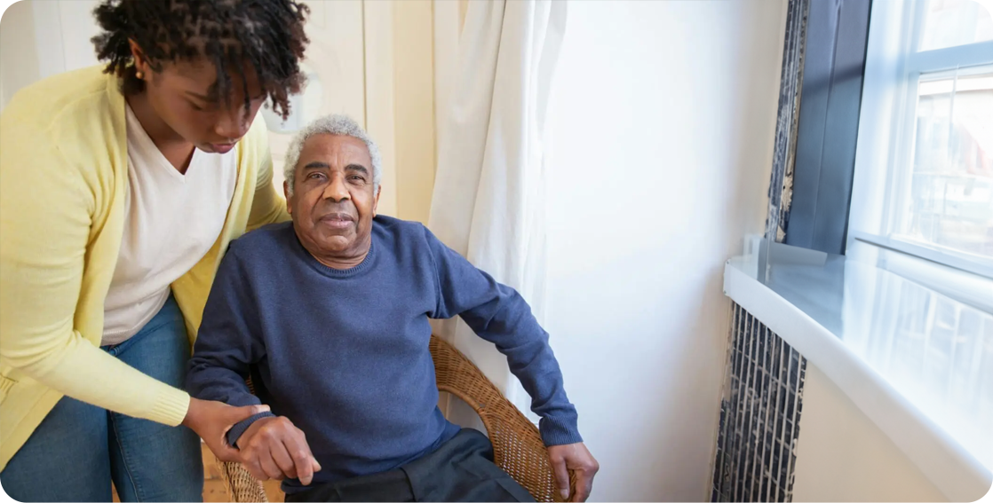 A man sitting in a chair with another person.